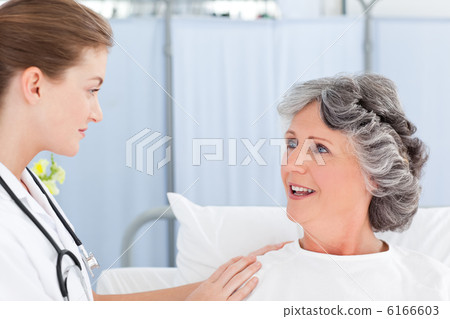 Mature woman talking with her nurse Mature woman talking with her nurse 6166603