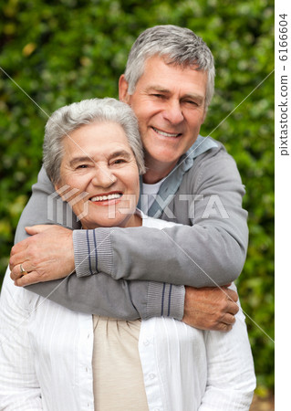 Mature couple hugging in the garden 6166604