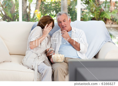 Seniors watching tv at home Seniors watching tv at home 6166827