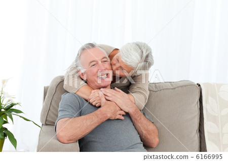 Lovers hugging while they are looking at the camera Lovers hugging while they are looking at the camera 6166995
