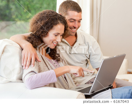 Couple working on their laptop at home 6167043