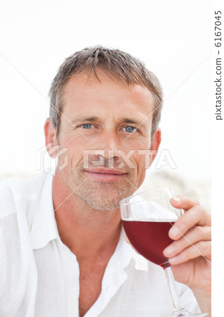Handsome man drinking some red wine Handsome man drinking some red wine 6167045