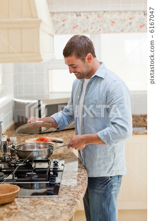Handsome man cooking in the kitchen Handsome man cooking in the kitchen 6167047