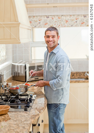 Handsome man cooking in the kitchen Handsome man cooking in the kitchen 6167048