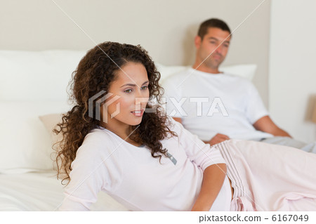 Thoughtful woman with her husband on the bed Thoughtful woman with her husband on the bed 6167049