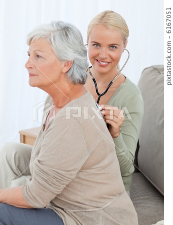Nurse taking the heartbreat of her patient at home Nurse taking the heartbreat of her patient at home 6167051