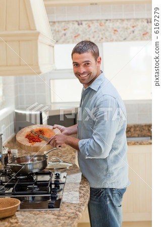 Handsome man cooking in the kitchen Handsome man cooking in the kitchen 6167279
