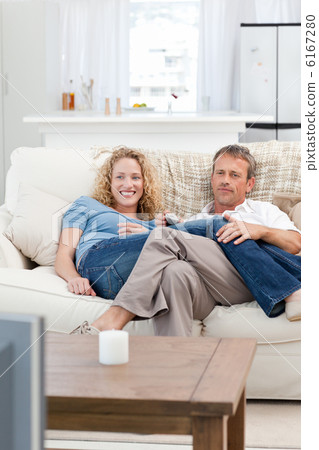 Lovers watching tv in the living room at home Lovers watching tv in the living room at home 6167280