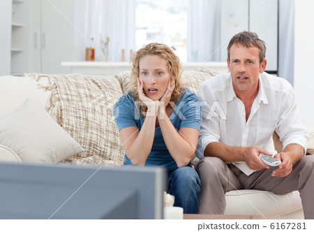 Lovers watching tv in the living room at home 6167281