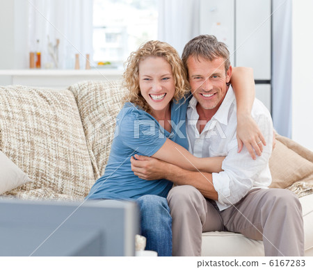 Lovers watching tv in the living room at home 6167283