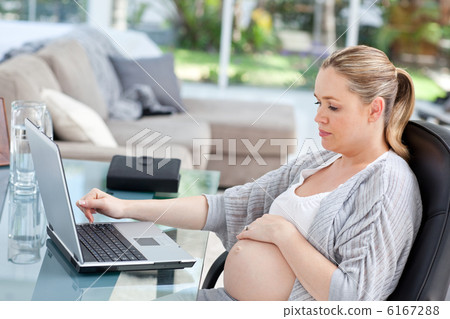 Worried pregnant woman calculating her domestic bills 6167288