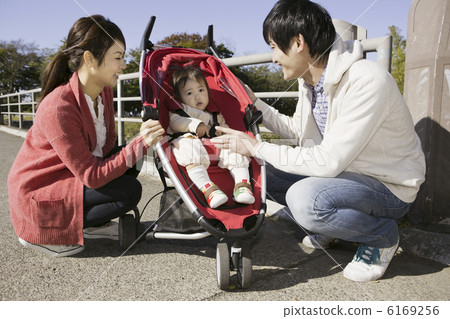 Parents speaking to a baby on a stroller 6169256
