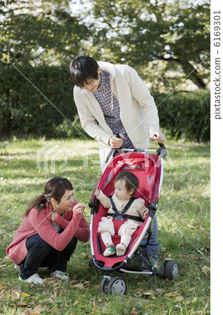 Babies and young parents taking a walk in the park 6169301