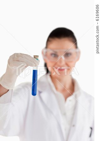 Dark-haired woman conducting an experiment 6169686