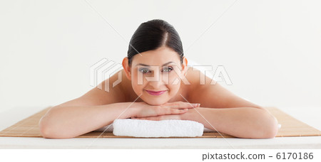 Brunette relaxing while looking at the camera 6170186