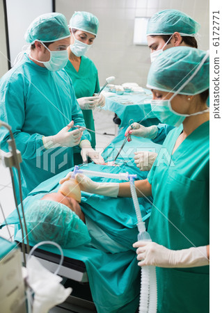 Concentrated surgeon team operating 6172771