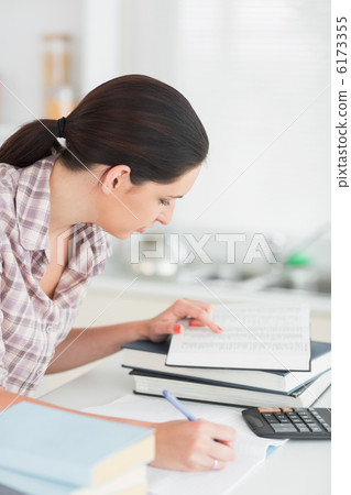 Woman working on a book 6173355