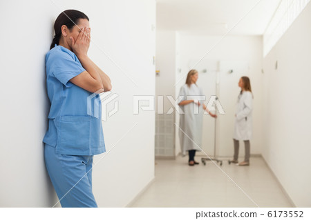 Nurse with head in hands 6173552