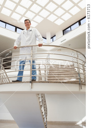 Doctor standing upstairs looking down 6173713