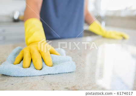 Woman cleaning the counter 6174017