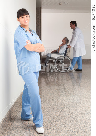Proud nurse standing in the hallway Proud nurse standing in the hallway 6174089