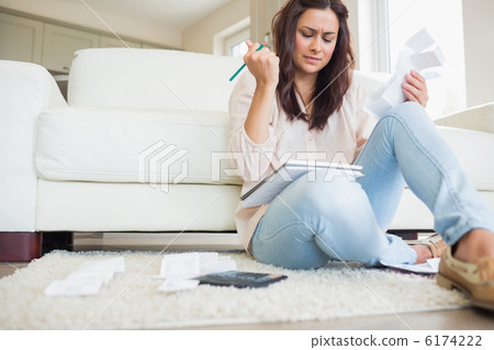 Young woman getting stressed over bills 6174222