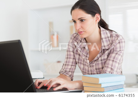 Woman working on a computer Woman working on a computer 6174355