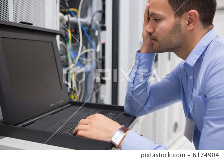 Man running diagnostics of servers Man running diagnostics of servers 6174904