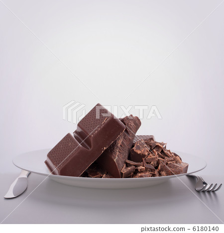 Chocolate bars stack on plate. 6180140