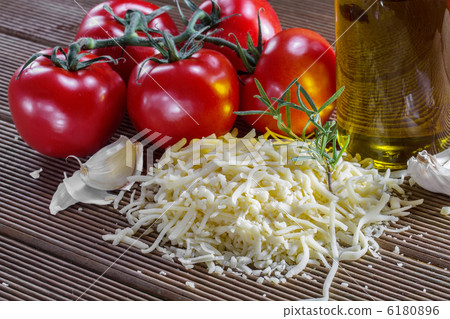 Grated cheese and tomatoes on a board Grated cheese and tomatoes on a board 6180896