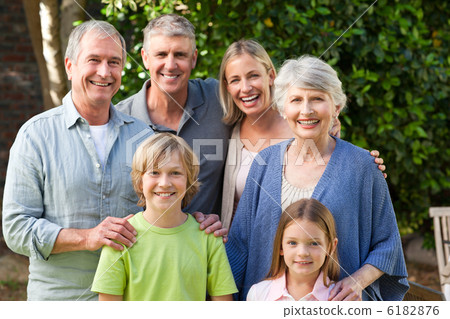 Family looking at the camera in the garden Family looking at the camera in the garden 6182876