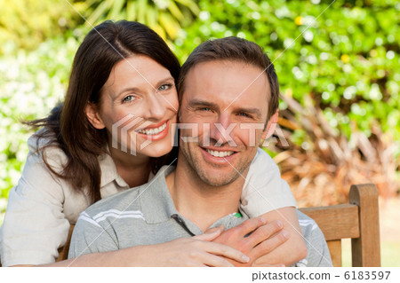 Glad couple hugging in the garden Glad couple hugging in the garden 6183597