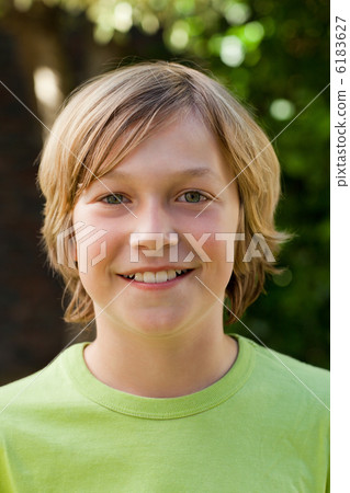 Little boy looking at the camera in the garden 6183627