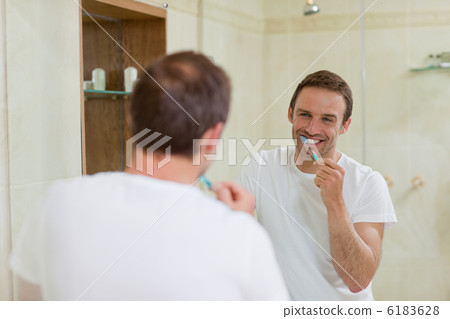 Man brushing his teeth Man brushing his teeth 6183628