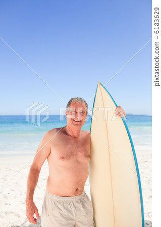Senior man with his surfboard Senior man with his surfboard 6183629