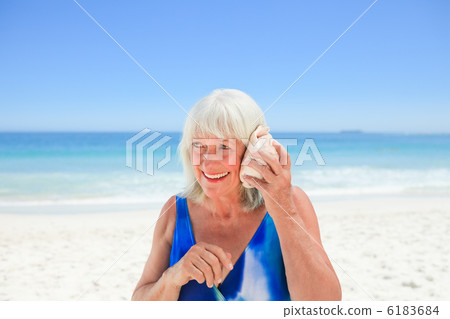 Woman listening to her shell 6183684