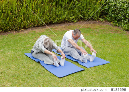 Senior couple doing their streches Senior couple doing their streches 6183696