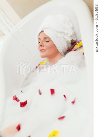 Pretty woman taking a relaxing bath with a towel on her head Pretty woman taking a relaxing bath with a towel on her head 6183698