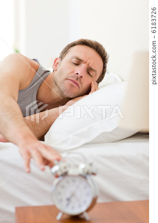 Man waking up in his bed 6183726