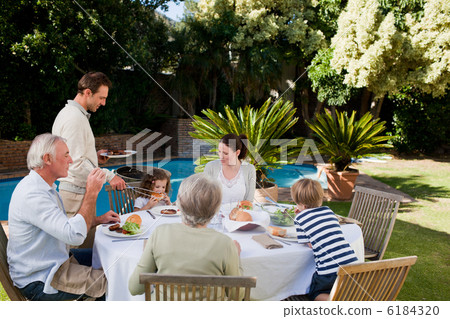 Family eating in the garden Family eating in the garden 6184320