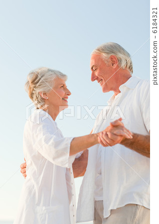 Senior couple dancing on the beach Senior couple dancing on the beach 6184321