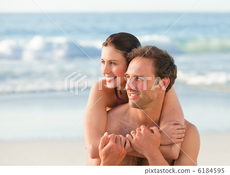 Enamored couple hugging on the beach Enamored couple hugging on the beach 6184595