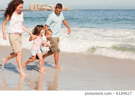 Family running on the beach Family running on the beach 6184627