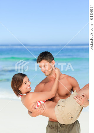 Man carrying his wife at the beach Man carrying his wife at the beach 6184954