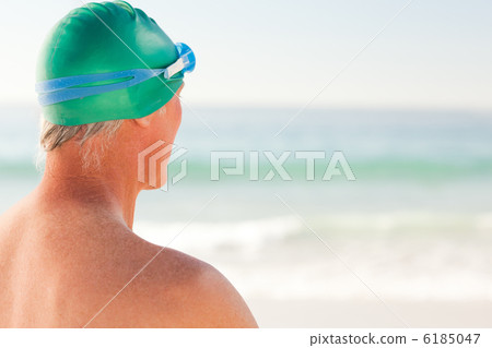 Smiling senior man at the beach 6185047