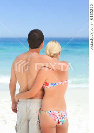 Woman huging her husband on the beach 6185236