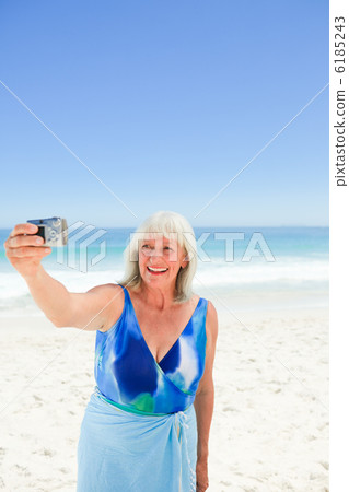 Woman taking a photo of herself 6185243