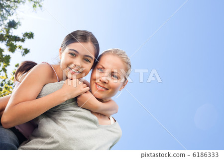 Mother and her daughter laughting in the park Mother and her daughter laughting in the park 6186333