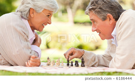Elderly couple playing chess Elderly couple playing chess 6186444