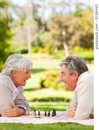 Retired couple playing chess 6186445